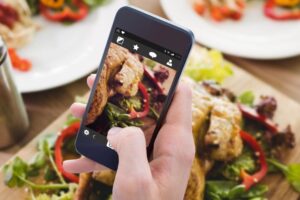 Food blogger taking a picture of a dish